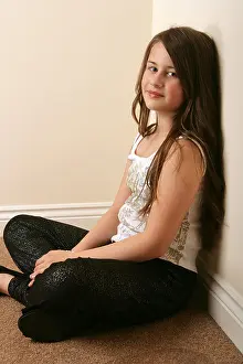 Years Prints: Portrait of a pretty 11 year old girl sitting crossed legged
