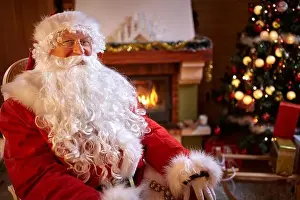 Portrait of real Santa Claus near decorated Christmas tree