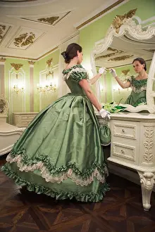 Young Girl Prints: Portrait of retro baroque fashion woman wearing green vintage dress at old palace interior