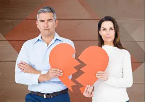 Solemn Prints: Portrait of sad couple holding broken hearts