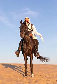 Saudi Arabia Prints: Portrait of a Saudi man with his black stallion