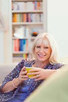 Coffee Cup Prints: Portrait smiling senior woman drinking coffee on sofa