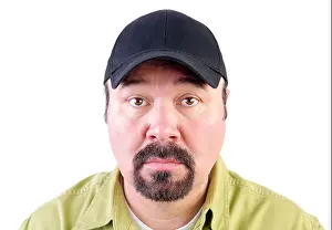 Intense Prints: Portrait of staring man with goatee wearing baseball cap, white background