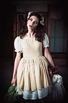 Gaze Prints: Portrait of a strange young girl with dolls in hands