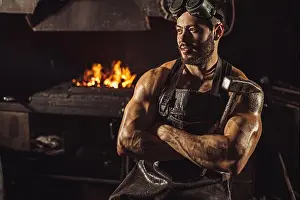 Craftsman Prints: portrait of strong muscular blacksmith man wearing black apron