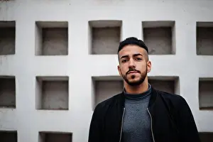 Mauritanian Prints: Portrait of stylish arab beard man wear grey turtleneck and black jaket. Arabian model guy