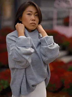 Skirt Prints: Portrait of a stylish young Asian woman with pensive expression standing
