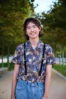 Taiwanese Prints: Portrait of a Taiwanese guy smiling and looking at camera in a park