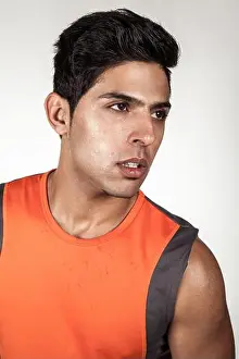 Exhausted Prints: Portrait of tired handsome brunette sporty man wearing orange sports clothing looking away with exhausted facial