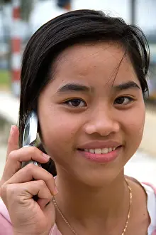 Cultural Travel Prints: Portrait of a Vietnamese girl using a cell phone in Hue Vietnam