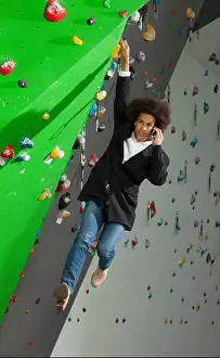 Climber Prints: portrait of woman on artificial exercise climbing wall