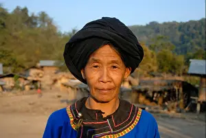 Ethnology Prints: Portrait of a woman of the Lolo ethnic group in traditional colourful blue dress and black turban