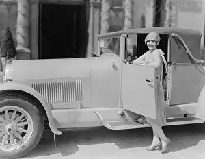 Posed Prints: Portrait of woman posing with car