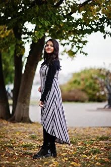 Malaysian Prints: Portrait of young beautiful indian or south asian teenage girl in dress posed at autumn park