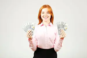 Blouse Prints: Portrait of young beautiful redhead woman with fistful of money holding one hundred dollar bill stack like fan