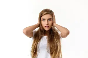 Suffer Prints: Portrait of young beautiful woman closes her ears with hand on white background
