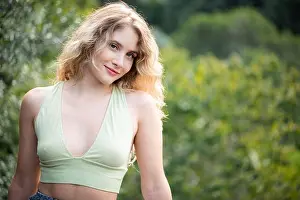 Crop Top Prints: A portrait of a young blonde woman wearing a green crop top in a park