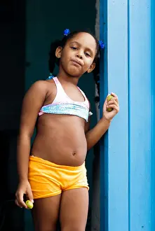 Cuban Prints: Portrait of a young girl outside of her home, Cuba