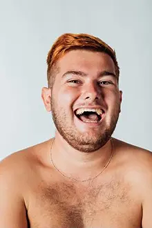 One Young Man Only Prints: Portrait of a young man with bare chest, laughing