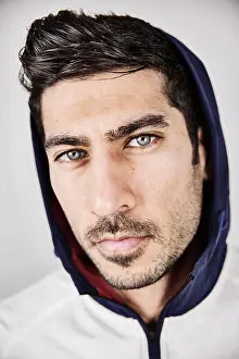 Stare Prints: Portrait of serious young man with blue eyes and stubble wearing hoodes jacket