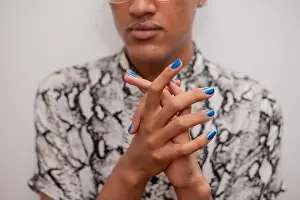 Generation Z Prints: Portrait of young man with blue nail polish