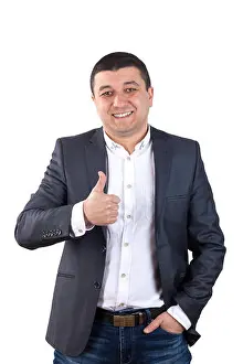 Shows Prints: Portrait of young man dressed in a white shirt and black suit and shows a sign ok