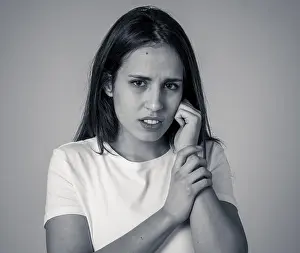 Pensive Prints: Portrait of a young sad woman, serious and concerned