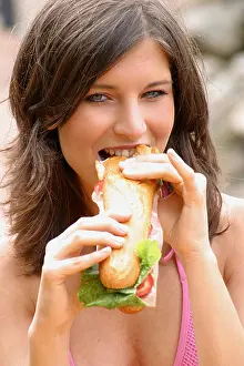 20 25 Prints: Portrait of a young woman eating hotdog