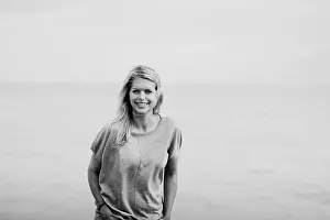 Waters Edge Prints: Portrait of a young woman with long blond hair at the ocean; Hastings, Sussex, England
