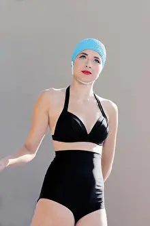 Only Women Prints: Portrait of young woman in retro bikini and swimming cap