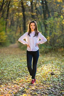 Backlight Prints: Posing on footpath in forest. A serious looking girls is posing in a pink shirt