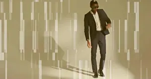 Single Person Prints: Posing mid adult man wearing dark suit and sunglasses leaning in studio