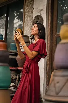Balinese Prints: Positive delighted girl that looking at pottery