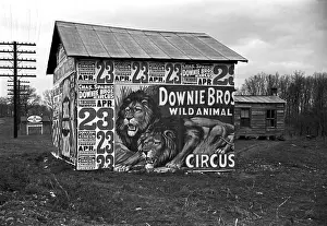 Posters covering a building near Lynchburg to advertise a Downie Bros