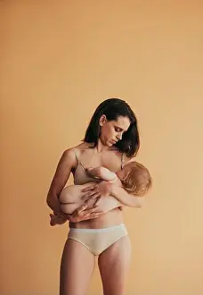 Postpartum mother breastfeeding her baby. Mom nursing baby