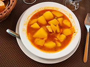 Potatoes Prints: Potatoes with cuttlefish in broth served on platter