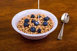 Blueberry Prints: Pouring Milk on Oat Cereal with Blueberries
