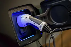Electro Prints: Power supply plugged into an electric car during charging
