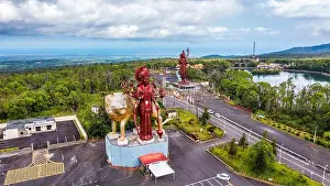 Lakeshore Prints: A powerful Statue of the Hindu goddess Durga Maa with a golden lion in sacred Ganga Talao