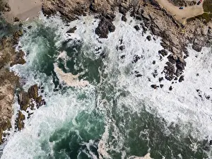 Powerful swells from the Pacific Ocean wash against the rocky coastline of the Monterey peninsula in California