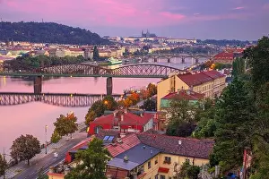 Prague at sunrise. Cityscape image of Prague, capital city of Czech Republic with St. Vitus Cathedral and five bridges over Vltava River at sunrise