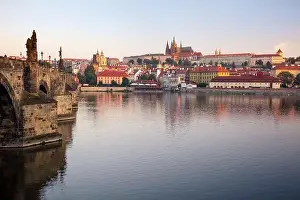 Prague at sunrise. Cityscape image of Prague, capital city of Czech Republic with St. Vitus Cathedral and Charles Bridge at sunrise