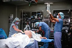 Childbirth Prints: pregnant woman is prepared for c section birth and delivery in operating room Doctor prepares iv drip