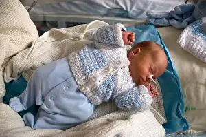 Asleep Prints: Premature newborn baby boy in hospital with a feeding tube attached to his nose