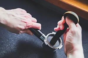 Coffee Cup Prints: Preparing coffee. The man holds a coffee grinder in his hand
