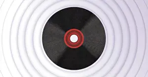 Layered Prints: Presenting record-like disc featuring red-ringed center hole on grey concentric ridges backdrop