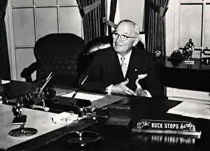 Statesmen Prints: Former President Harry Truman with 'The Buck Stops Here' sign on a recreation of his Oval Office desk