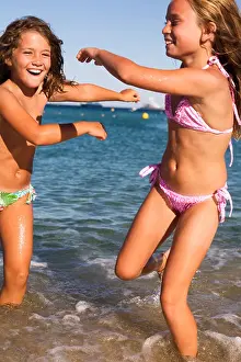 Active Prints: Pretty children playing and having fun on the beach