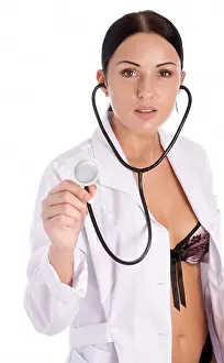 Young Beauty Prints: Pretty female doctor holding stethoscope isolated on white background