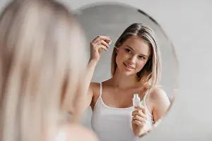 Girlish Prints: Pretty lady applying serum on face
